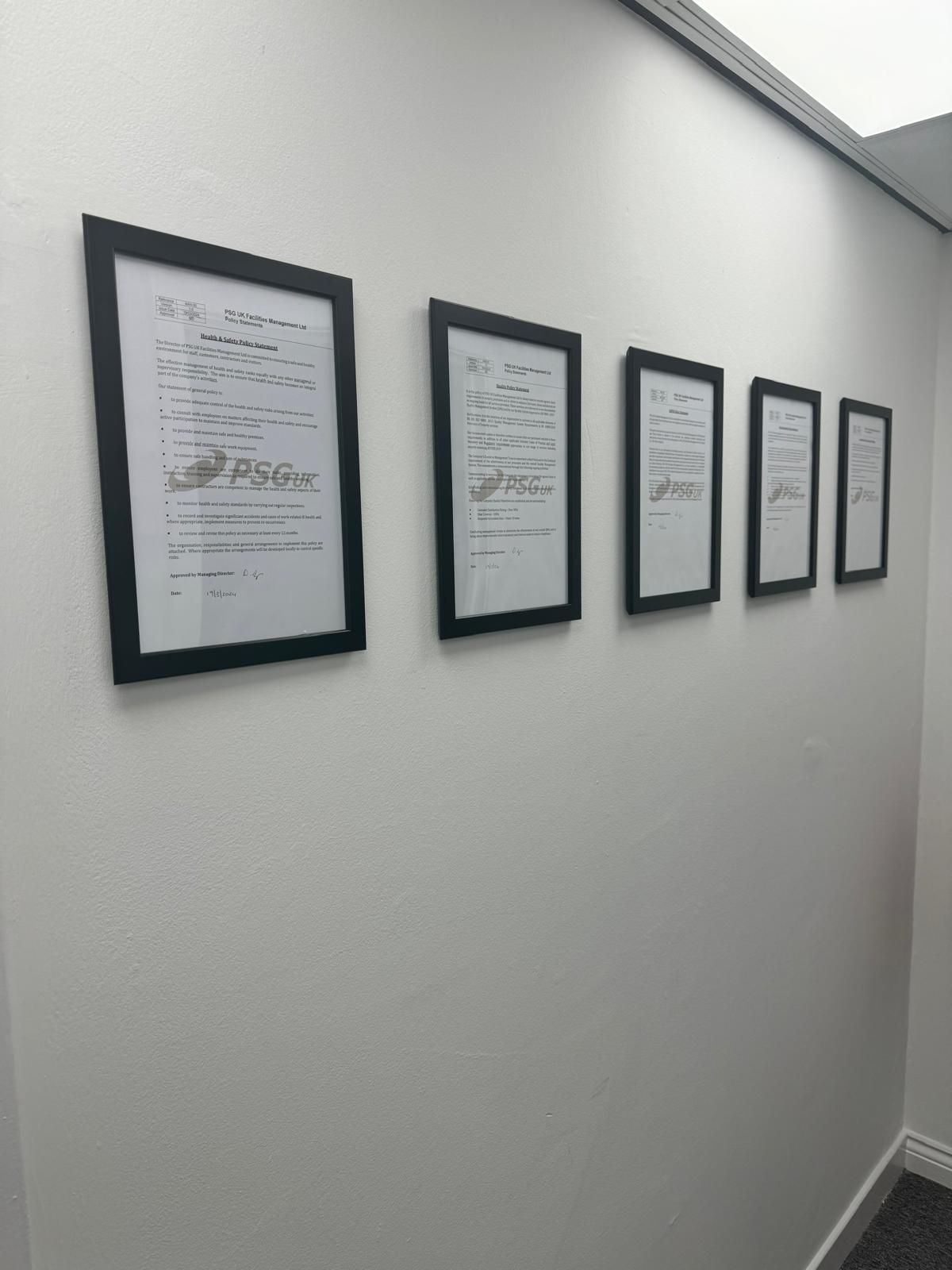 PSG UK policy documents displayed on office wall